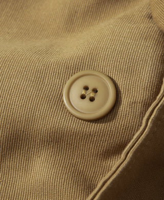 Khaki four-hole button on the deck vest's textured fabric