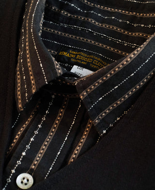 Close-up of shirt collar, brand label, and striped front placket