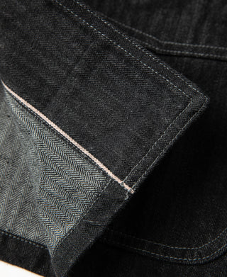 Black herringbone denim jacket selvedge seam detail with zigzag interior lining