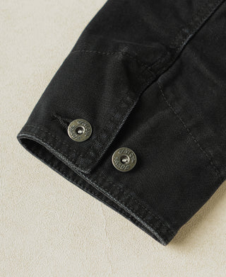 Black sleeve cuff with two snap buttons and stitched hem