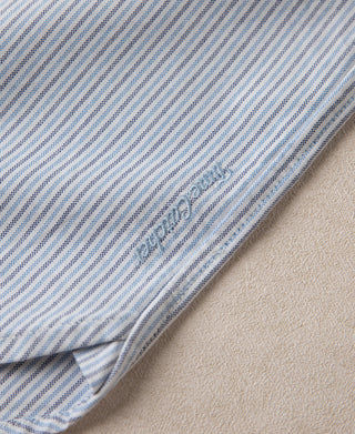 Blue-striped oxford shirt hem edge with visible stitching
