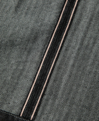 Black denim jacket button placket with double stitch and selvedge edge