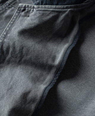 Gray-blue canvas jacket with overlapping front storm flap