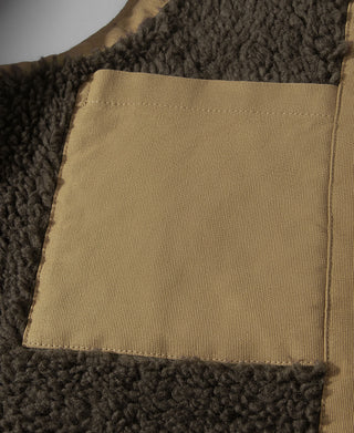 Deck vest interior with a khaki fabric pocket and dark curly lining