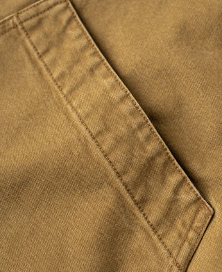 Khaki canvas field jacket with close-up of a stitched seam