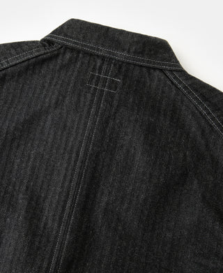Black denim jacket yoke with pointed collar seam and contrast topstitch