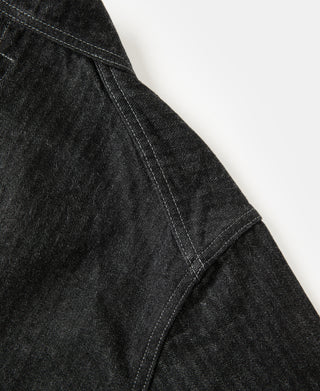 Black denim jacket side seam with curved panel and neat edge stitching