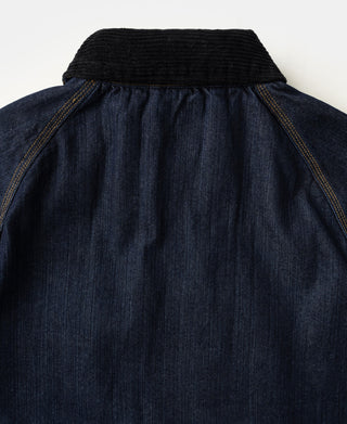 Indigo denim field jacket with ribbed high collar and button placket.
