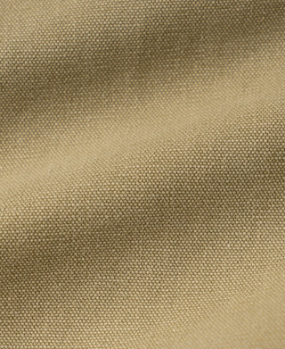 Washed khaki duck canvas fabric close-up, visible woven texture