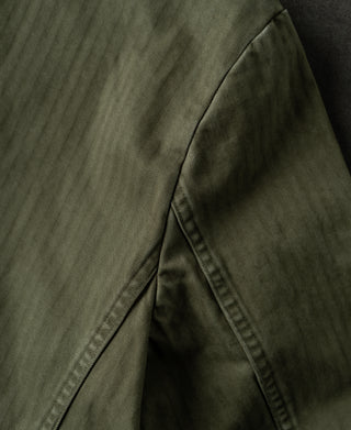 Olive blazer side panel with curved seam and tailored stitching