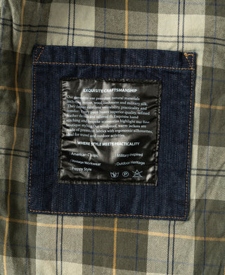 Indigo denim field jacket interior care label on plaid lining.
