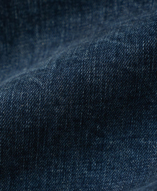 Close-up of indigo denim fabric texture with fine woven grain
