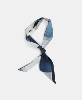 Vintage printed neck scarf in blue, white, and gray, tied with two pointed ends.