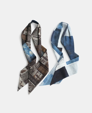 Two vintage printed neck scarves, one in blue and white geometric blocks and one in brown and blue patterns