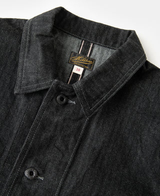 Black denim jacket collar close-up with button and interior brand label