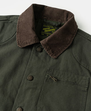 Olive jacket close-up with brown corduroy collar, snap buttons, and chest pocket