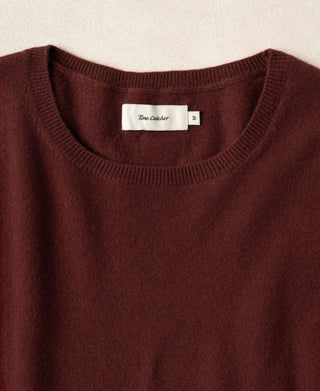 Maroon crewneck sweater with ribbed collar and neck label