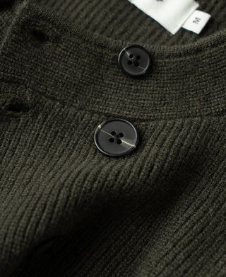 Olive knit cardigan placket with round dark buttons and ribbed neckline