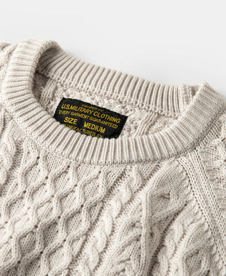Cream cable knit crewneck sweater with ribbed collar and interior neck label