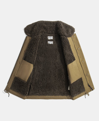 Open khaki deck vest showing its dark shearling lining and inner pockets
