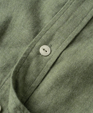 Sage work shirt placket with round white buttons and collar seam detail