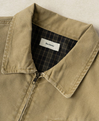 Duck canvas cossack jacket neckline detail: plaid inner collar and zip pull at center front