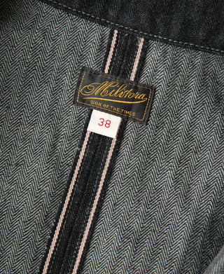 Black denim jacket inside waist label showing size 38