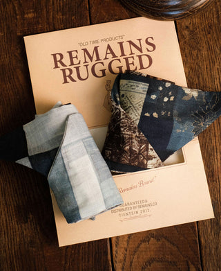 Two patterned neck scarves folded to show blue, white, and brown prints
