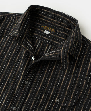 Close-up of open collar and front buttons on the striped work shirt