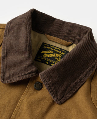 Khaki hunting jacket detail: ribbed brown collar and snap buttons