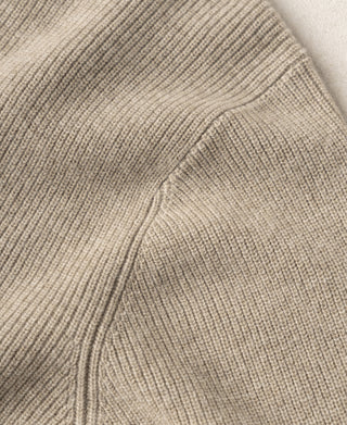Ecru knit cardigan close-up of shoulder seam and ribbed knit panels