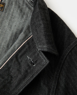 Black denim jacket side pocket and stitch detail close-up