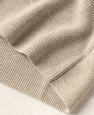 Ecru knit cardigan hem close-up with ribbed edging and cuff texture
