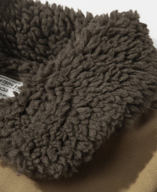 Deck vest close-up showing the thick, curly dark shearling collar
