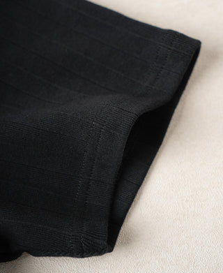 Vintage black ribbed cotton T-shirt hem close-up