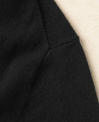 Black sweater shoulder and sleeve seam with fine rib knit detail