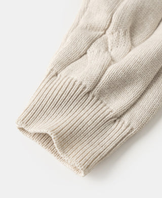 Ribbed knit cuff and hem on apricot cable knit sweater