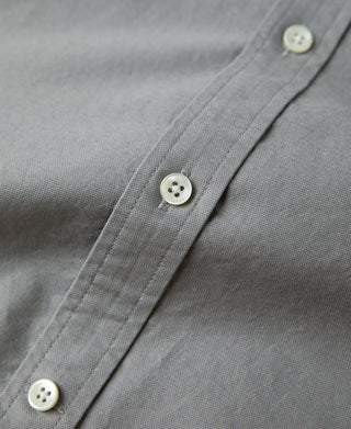 Gray button placket on oxford button-down shirt with three white buttons