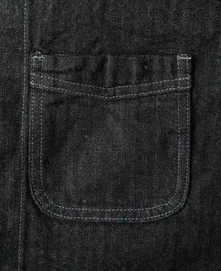Black denim jacket chest pocket with flap and contrast stitching close-up