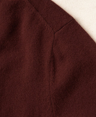 Maroon crewneck sweater back panel with subtle seam detail