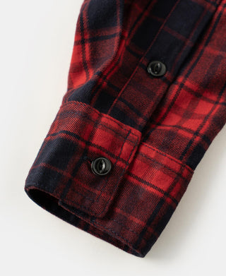 Red and dark navy plaid heavyweight work shirt sleeve with black button cuff and seam stitching