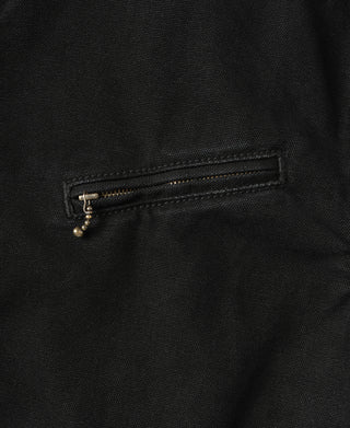 Black jacket pocket with brass zipper and rectangular flap