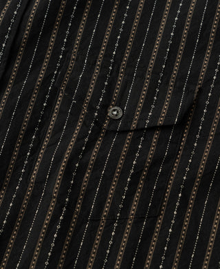 Close-up of the shirt's buttoned chest pocket and vertical stripe pattern