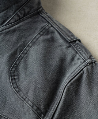 Gray-blue canvas hunting jacket shoulder with curved panel seams