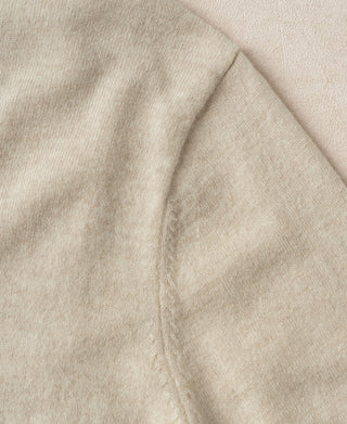 Apricot merino wool crewneck sweater knit texture close-up