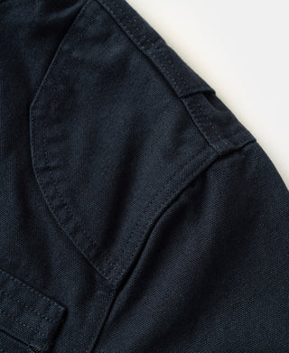 Navy jacket sleeve and shoulder seam with angled pocket panel