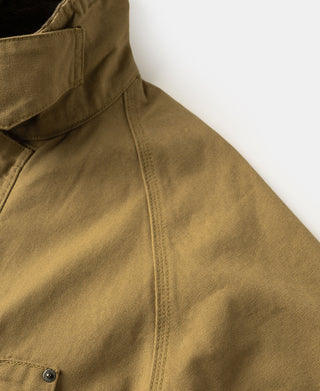 Khaki canvas field jacket shoulder and front seam close-up with side button hardware