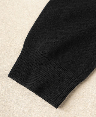Black sweater sleeve cuff with ribbed knit hem edge