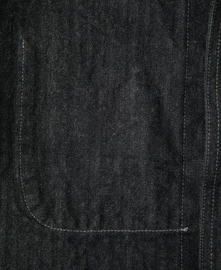 Black denim jacket lower panel with visible seam and topstitching close-up