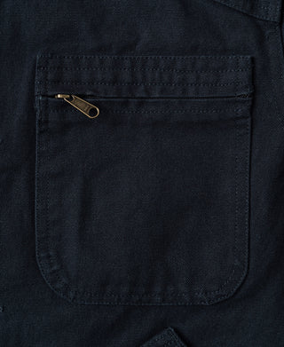 Navy jacket front chest pocket with metal pin detail and stitch lines